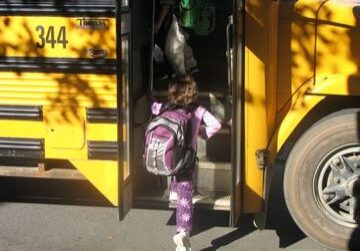 Student getting on school bus