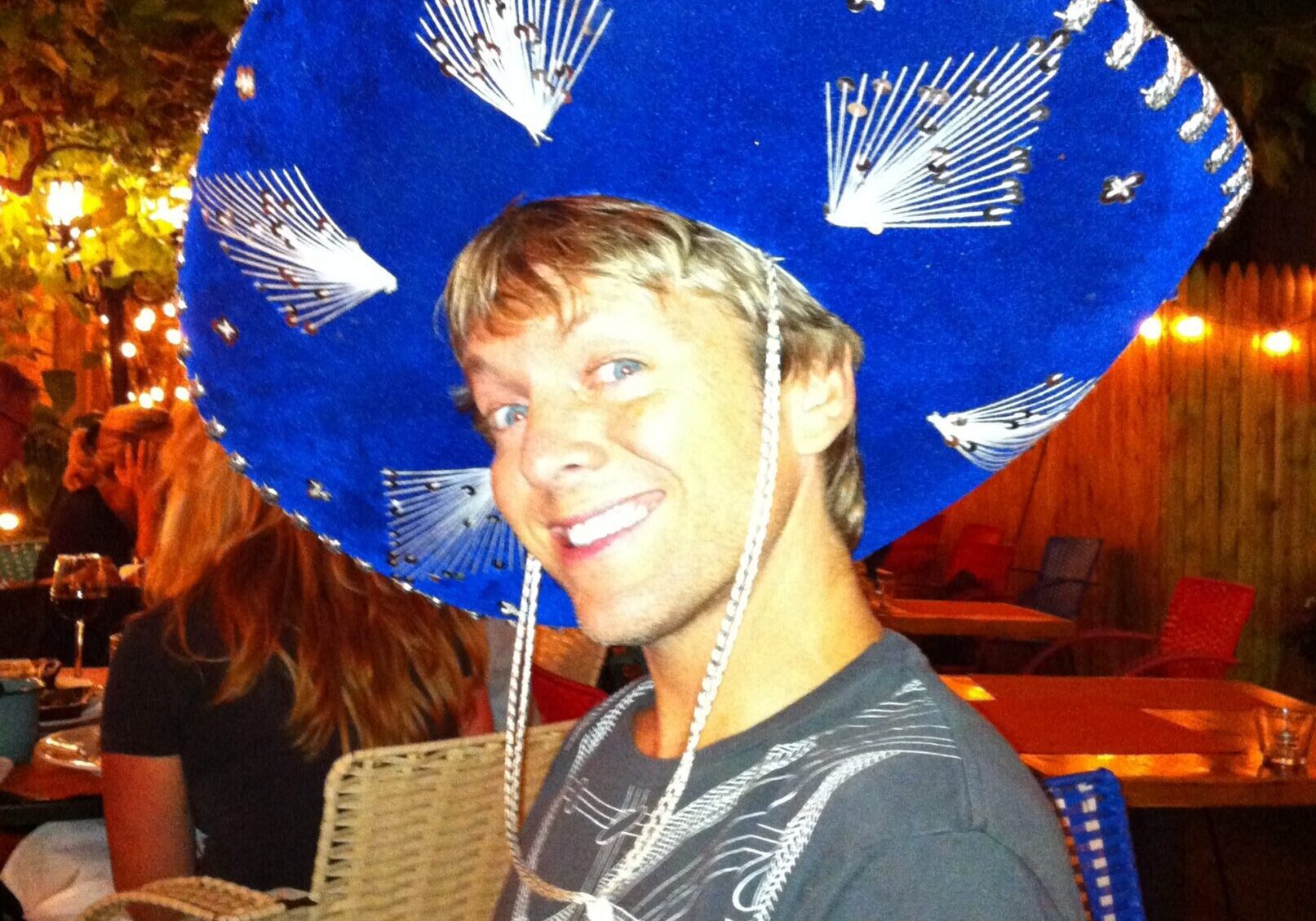 Person in sombrero at outdoor gathering