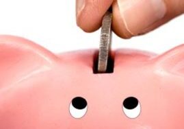 Saving money in piggy bank slot