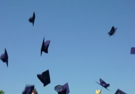 Sky filled with flying graduation caps