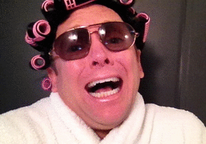 Laughing person with curlers and sunglasses
