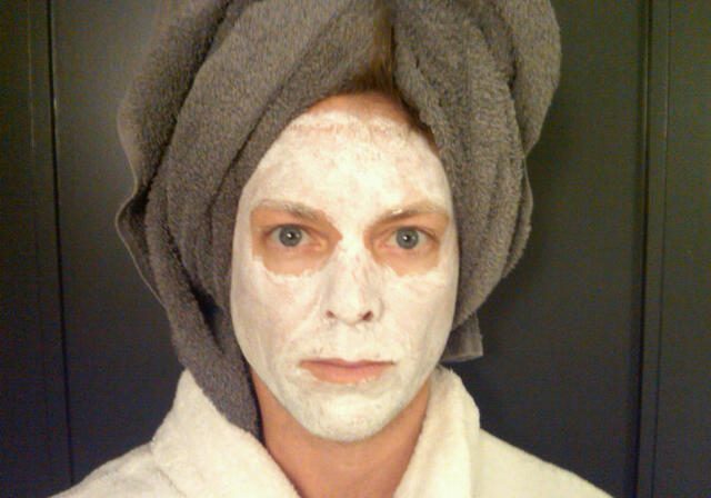Individual wearing facial mask and robe
