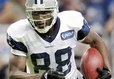 Player in white jersey holding football