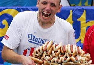 Enthusiastic participant with numerous hot dogs.