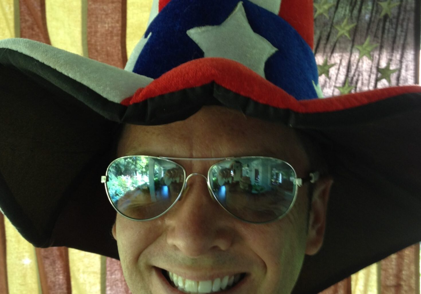 Man wearing patriotic hat and sunglasses