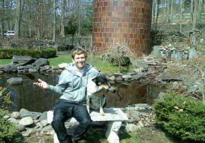 Person and dog near garden pond