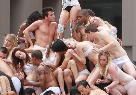 People in white posing creatively outdoors