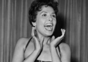 Woman smiling with hands on cheeks