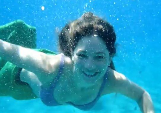 Smiling swimmer in turquoise water