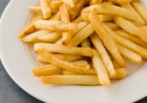 Golden fries on white plate
