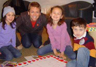 Children and adult around a board game