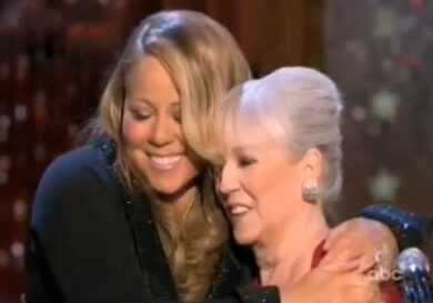 Two women embracing on stage