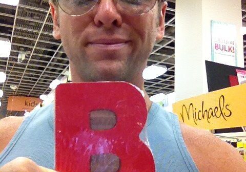Shopper displays red B at Michaels