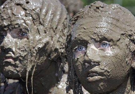 Mud-covered faces at festival