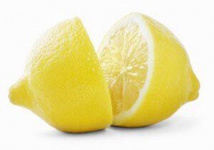 Whole and sliced lemon on white background.