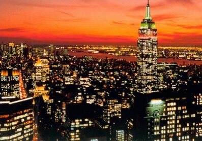 City skyline at sunset with glowing lights