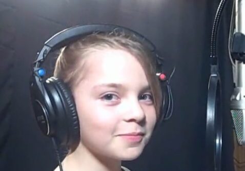 Young girl recording with microphone