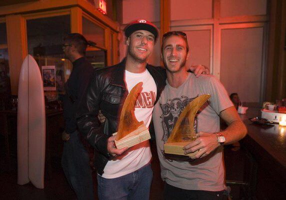 Smiling duo with awards at event