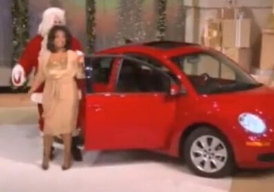 Red car presentation with Santa and woman