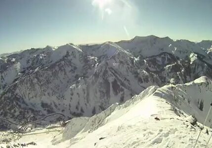 Snowy mountain peaks under bright sun