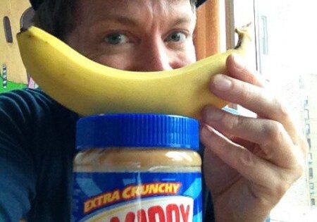 Smiling man with banana and peanut butter