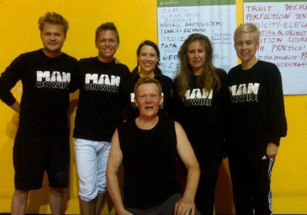 Group posing in matching "Man on Wire" shirts