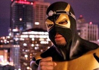 Superhero overlooking nighttime cityscape