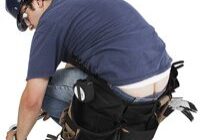 Construction worker bending down with tools