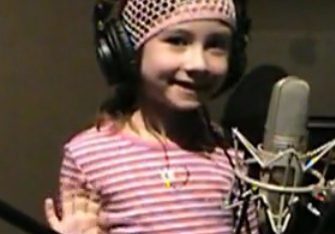 Smiling child recording vocals