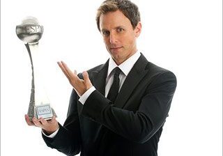 Man holding a trophy in suit