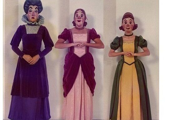 Characters in colorful theatrical costumes