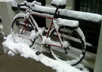 Red bike buried in fresh snow
