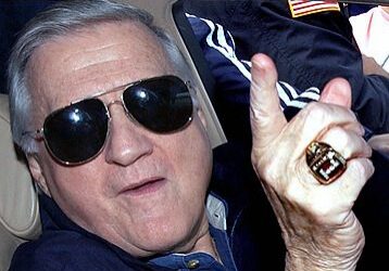 Man wearing sunglasses and ring gestures