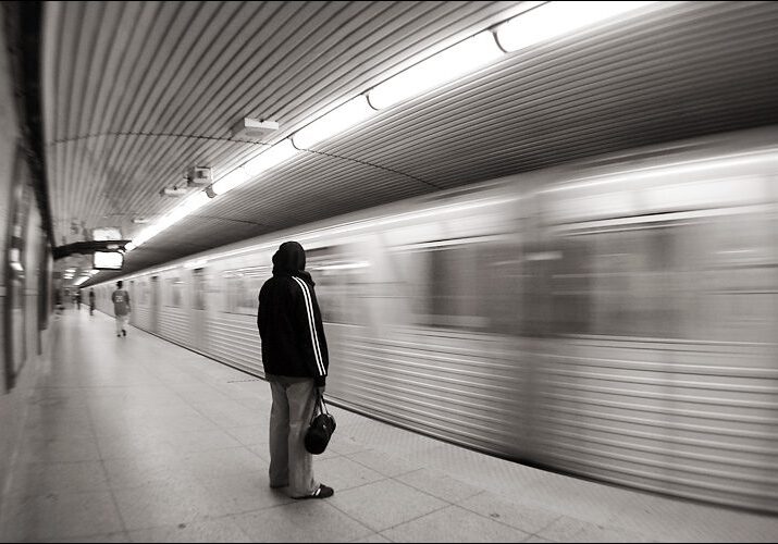 Person waiting as train speeds by