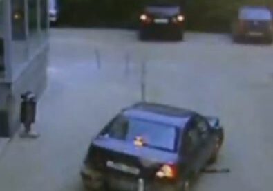 Car stuck on metal pole