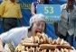 Person eating hot dogs in competition