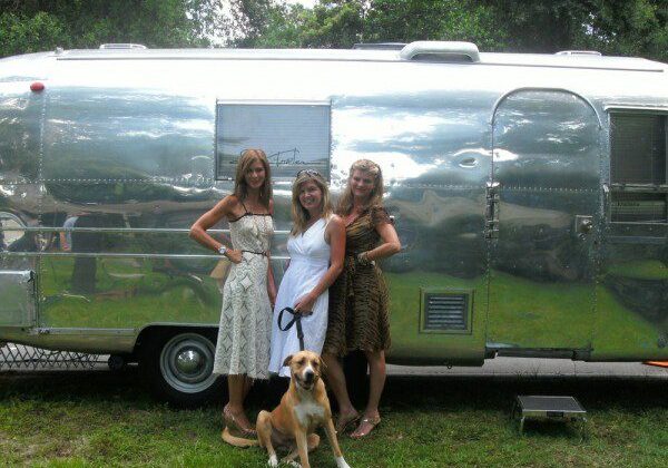 Women and dog in front of camper