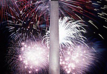 Monument illuminated by colorful fireworks display
