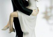 Bride and groom figurine embrace